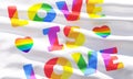 LOVE IS LOVE Pride rainbow flag closeup view background for LGBTQIA+ Pride month, sexuality freedom, love diversity celebration Royalty Free Stock Photo