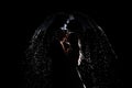 Love in the rain. Silhouette of kissing couple under umbrella. couple under an umbrella at night in the rain Royalty Free Stock Photo