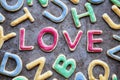 Love in red icing amongst letter shaped cookies, close-up Royalty Free Stock Photo