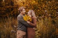 Love, relationship, family and people concept - close up of couple with maple leaf in autumn park Royalty Free Stock Photo