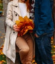 Love, relationship, family and people concept - close up of couple with maple leaf kissing in autumn park Royalty Free Stock Photo