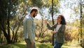 Love, relationship, family and people concept - smiling couple in the autumn park among the yellow leaves having fun Royalty Free Stock Photo