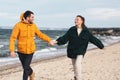 couple running along autumn beach Royalty Free Stock Photo