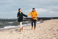 couple running along autumn beach Royalty Free Stock Photo