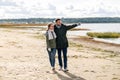 Couple walking along autumn beach