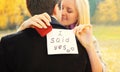 Love, relationships, engagement and wedding concept - man proposes a woman to marry, red box ring, happy young romantic couple