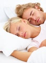 Love, relax and a couple sleeping in bed in the morning in their home together for holiday or vacation. Face, dream or