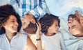 Love, relax and happy family in bed, laughing, bonding and resting in their bedroom together from above. Black, cheerful Royalty Free Stock Photo