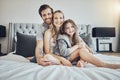 Love, relax and portrait of a family on a bed embracing, bonding and resting together at their home. Happiness, mother Royalty Free Stock Photo