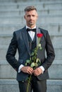 love rendezvous concept. grizzle tuxedo man with love rose. flower gift for love day