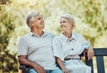 Love, retirement and couple on bench in park with smile, relax and bonding time in nature together. Romance, senior man Royalty Free Stock Photo