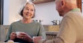 Love, retirement and an elderly couple drinking tea in the dining room of their home together in the morning. Smile