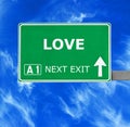 LOVE road sign against clear blue sky Royalty Free Stock Photo