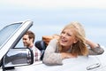 They love roadtrips. a young couple enjoying a drive in a convertible.