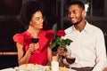 Man Giving Rose To Woman Having Valentine`s Date In Restaurant