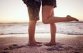 Love, romance and legs on beach, couple in sunset on summer holiday together. Ocean, man and woman with feet in sand Royalty Free Stock Photo