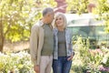 Love and romance in senior age concept. Loving senior spouses embracing and smiling to each other in their garden Royalty Free Stock Photo