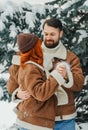 Love romantic couple lovestory. Brutal bearded man, bright red-haired girl woman in winter park. Romantic date, kissing Royalty Free Stock Photo