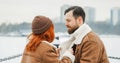 Love romantic couple lovestory. Brutal bearded man, bright red-haired girl woman in winter park. Romantic date, kissing Royalty Free Stock Photo