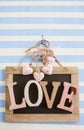 LOVE on rustic chalkboard on stripes Royalty Free Stock Photo