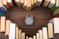 Love science concept. Heart shape of books and clock on wooden desk. Time to take a degree in natural Sciences