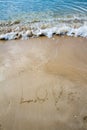 Love sea written on the beach.