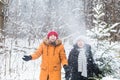 Love, season, friendship and people concept - happy young man and woman having fun and playing with snow in winter Royalty Free Stock Photo