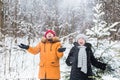 Love, season, friendship and people concept - happy young man and woman having fun and playing with snow in winter Royalty Free Stock Photo