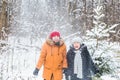 Love, season, friendship and people concept - happy young man and woman having fun and playing with snow in winter Royalty Free Stock Photo