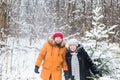 Love, season, friendship and people concept - happy young man and woman having fun and playing with snow in winter Royalty Free Stock Photo