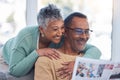 Love, senior couple and reading newspaper in living room of home. Retirement, relax and happy elderly man and woman Royalty Free Stock Photo