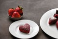 Love shape strawberry cake with some sugar powder topping and strawberry fruit in a plate Royalty Free Stock Photo
