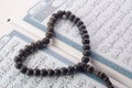 Love shape Tasbih (beads) on Holy Quran Royalty Free Stock Photo