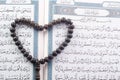 Love shape Tasbih (beads) on Holy Quran