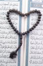 Love shape Tasbih (beads) on Holy Quran Royalty Free Stock Photo