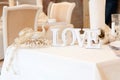 Love sign on table. Decor in restaurant. Peacock Royalty Free Stock Photo