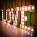 Love Sign Word Lighting Bulbs Against Barn Wall