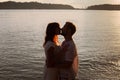 love, silhouette of couple kissing at sunset on the beach, honeymoon Royalty Free Stock Photo