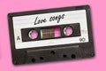 Love songs written on vintage audio cassette tape, pink background