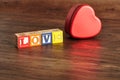 Love Spelled with colorful alphabet blocks and a tin Royalty Free Stock Photo