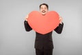 Love, st. valentine`s concept. Expression businessman holding big red heart Royalty Free Stock Photo