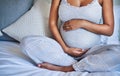 Love starts in the womb. a pregnant young woman relaxing on the bed at home. Royalty Free Stock Photo