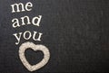 Love statement and Inspirational quote, reads me and you. Black background. White textured clear heart. Text space