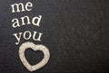 Love statement and Inspirational quote, reads me and you. Black background. White textured clear heart. Text space.