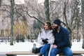 Love story of couple walking in city. Young business man in a blue jacket with a beard. And a cute woman in long coat Royalty Free Stock Photo