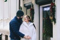 Love story of couple walking in city. Young business man in a blue jacket with a beard. And a cute woman in long coat Royalty Free Stock Photo