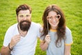 Love story. Happy together. Couple in love cheerful youth booth props. Couple relaxing green lawn. Man bearded hipster