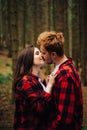 Love story photo  a couple in red shirts hugging and kissing on a hike. Beautiful couple in love in red shirts passionately Royalty Free Stock Photo