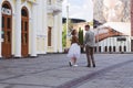 Love story of stylish funny couple: young man in a t-shirt. And a cute young woman in white skirt