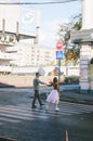 Love story of stylish funny couple: young man in a t-shirt. And a cute young woman in white skirt